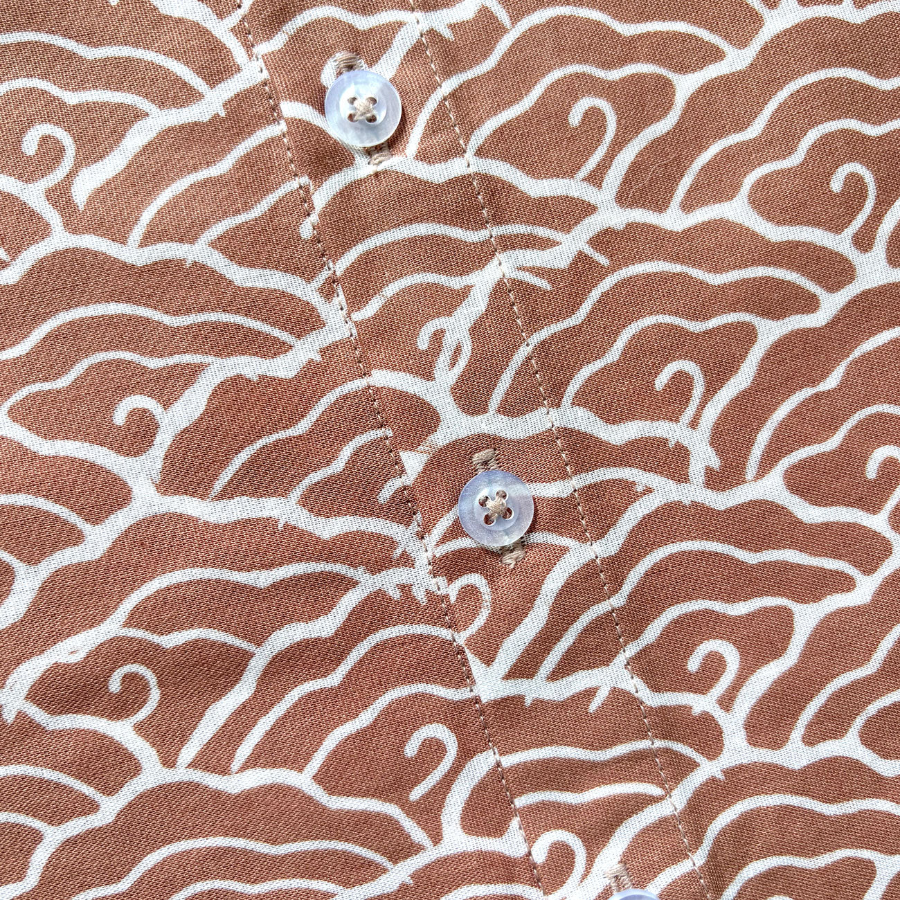 Close up of buttons on a mega mendung batik shirt