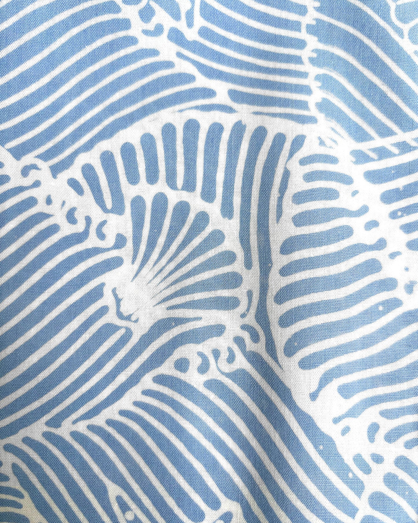Close-up of batik seashell pattern in blue and white