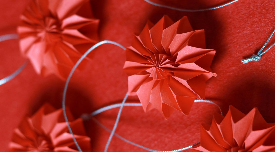 Close up of red Chinese New Year paper flowers with string