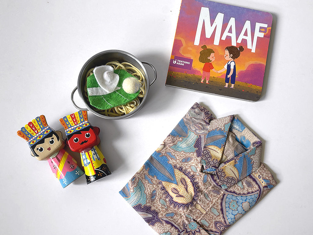 Flat lay of Indonesian toys for kids. Ondel-ondel,  pretend mie bakso, Boardbook in Bahasa and batik shirt