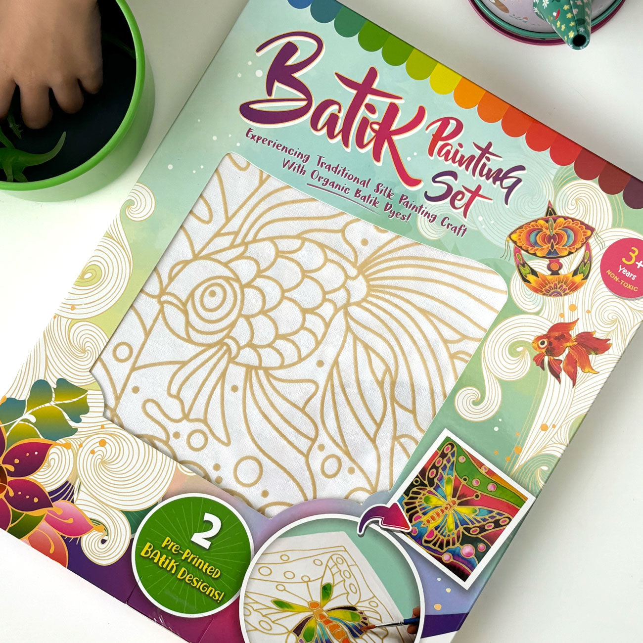 Flat lay of a 2 in 1 batik painting kit of the goldfish motif