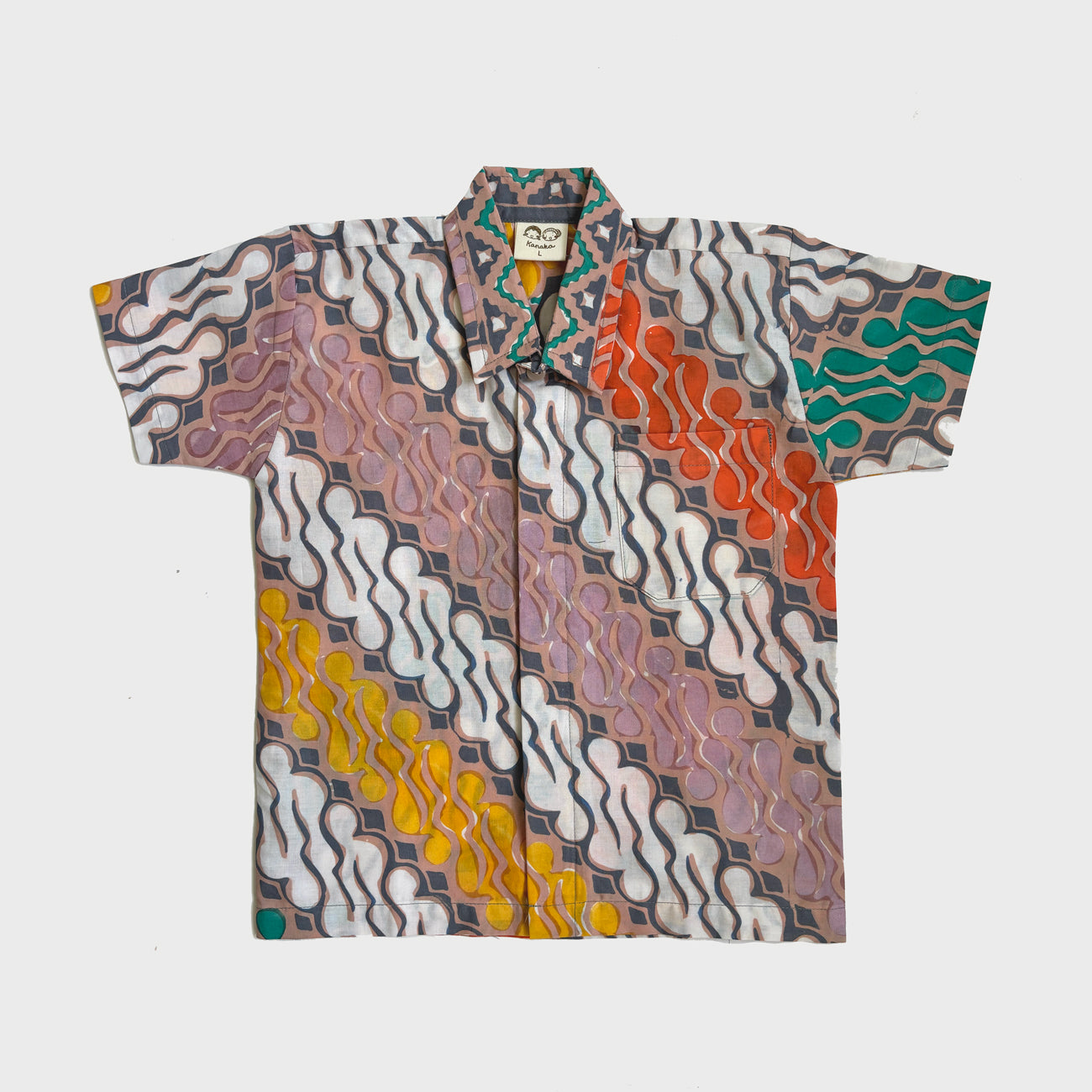 Flat lay of a parang batik shirt in brown, white, green and yellow for kids