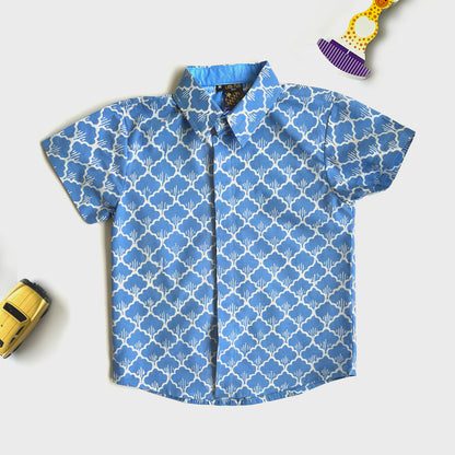 Bright blue batik shirt with a graphic floral design