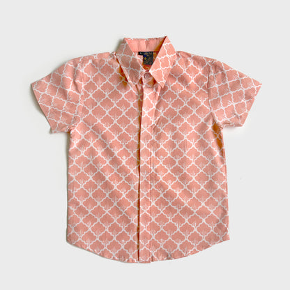 Bright peach batik shirt with a graphic floral design