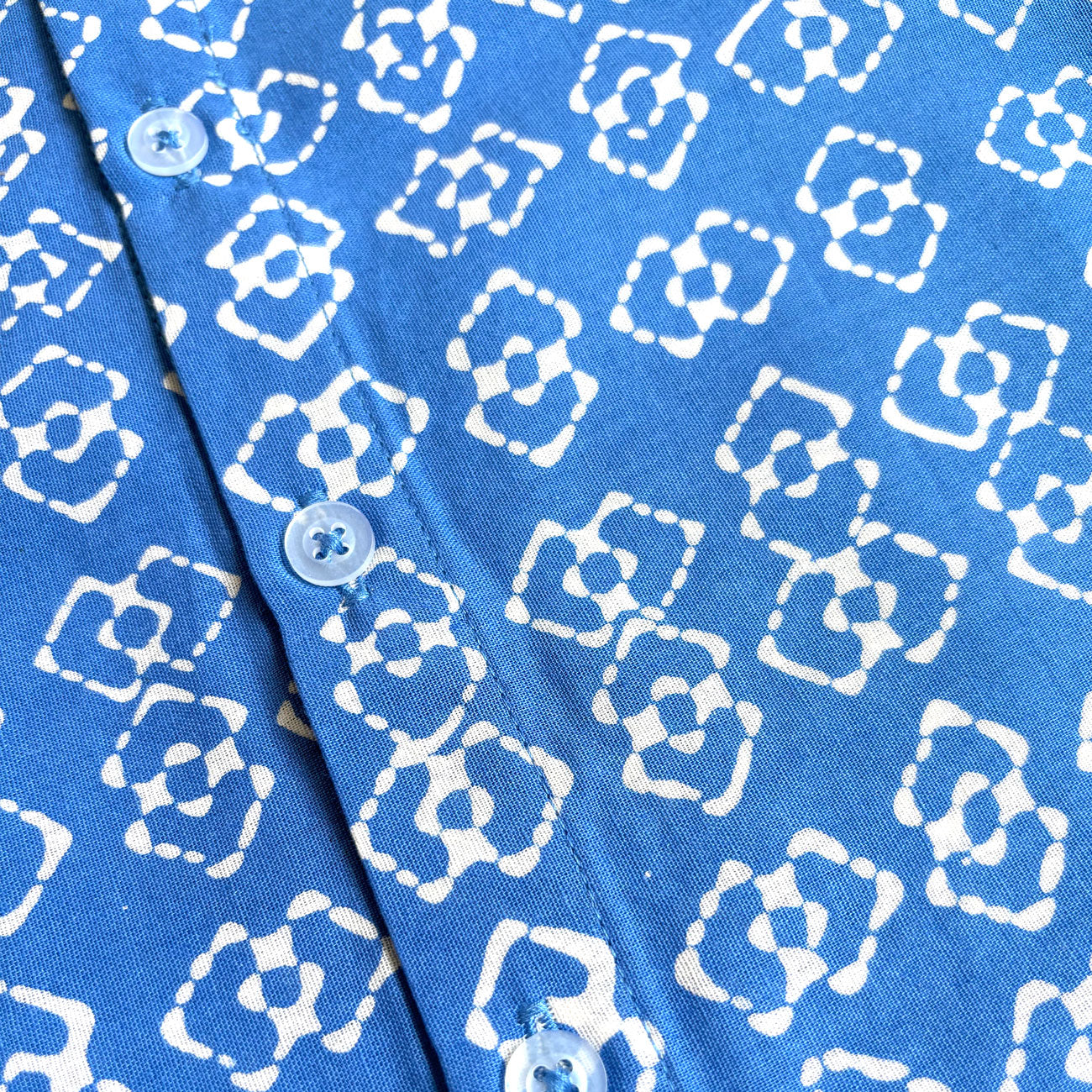 Buttons and close up of blue batik fabric