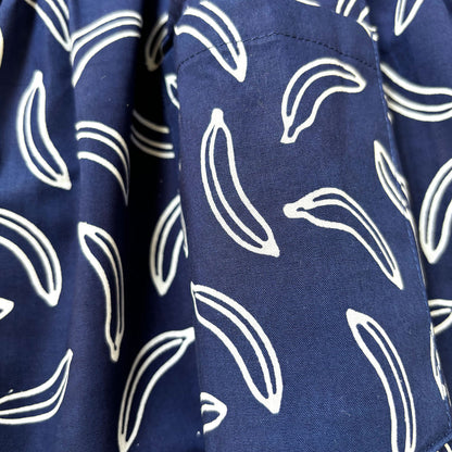 Close up of banana print on a navy blue batik dress