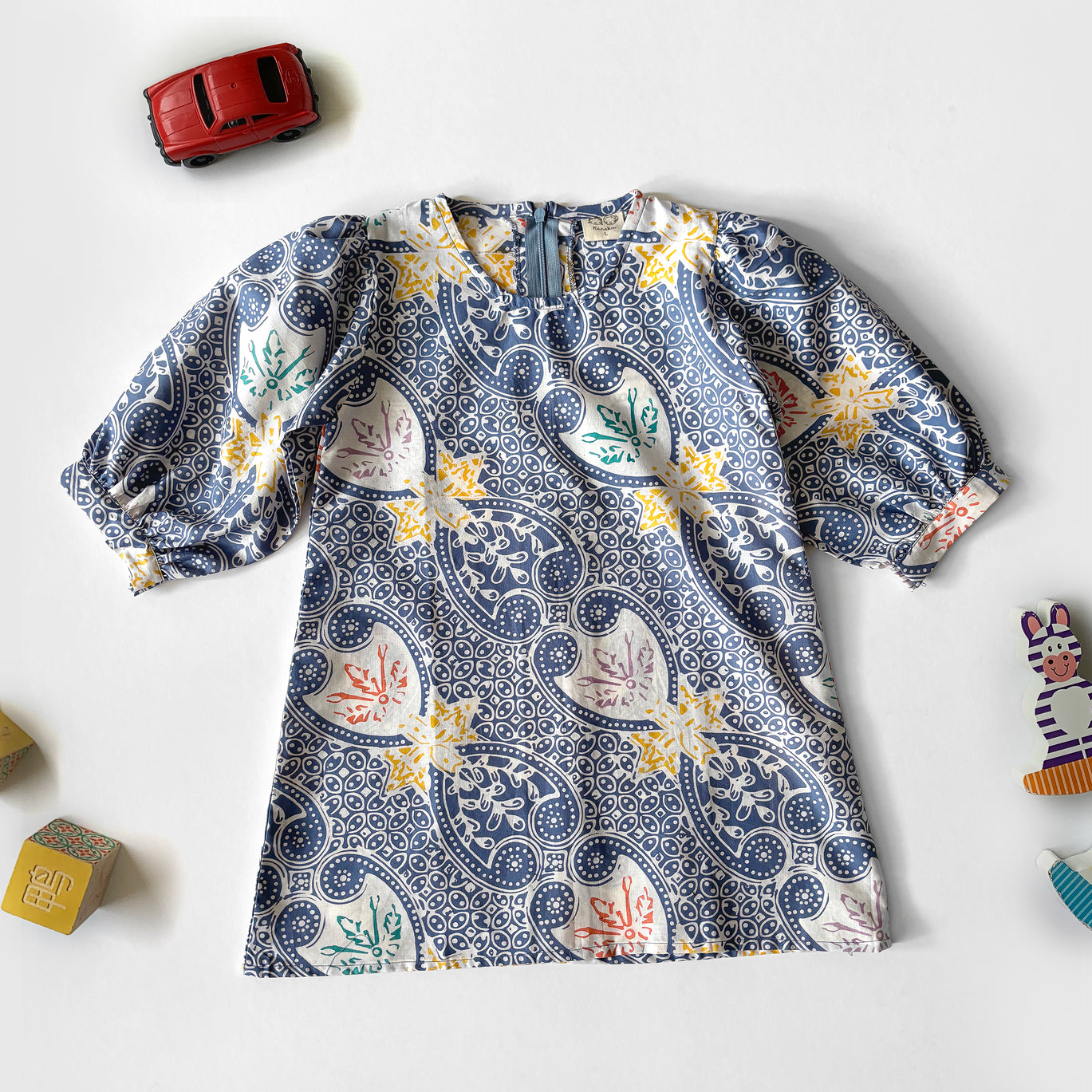 Flat lay of a blue, modern batik dress