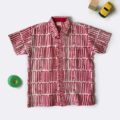 Red and gold batik shirt with squiggly lines