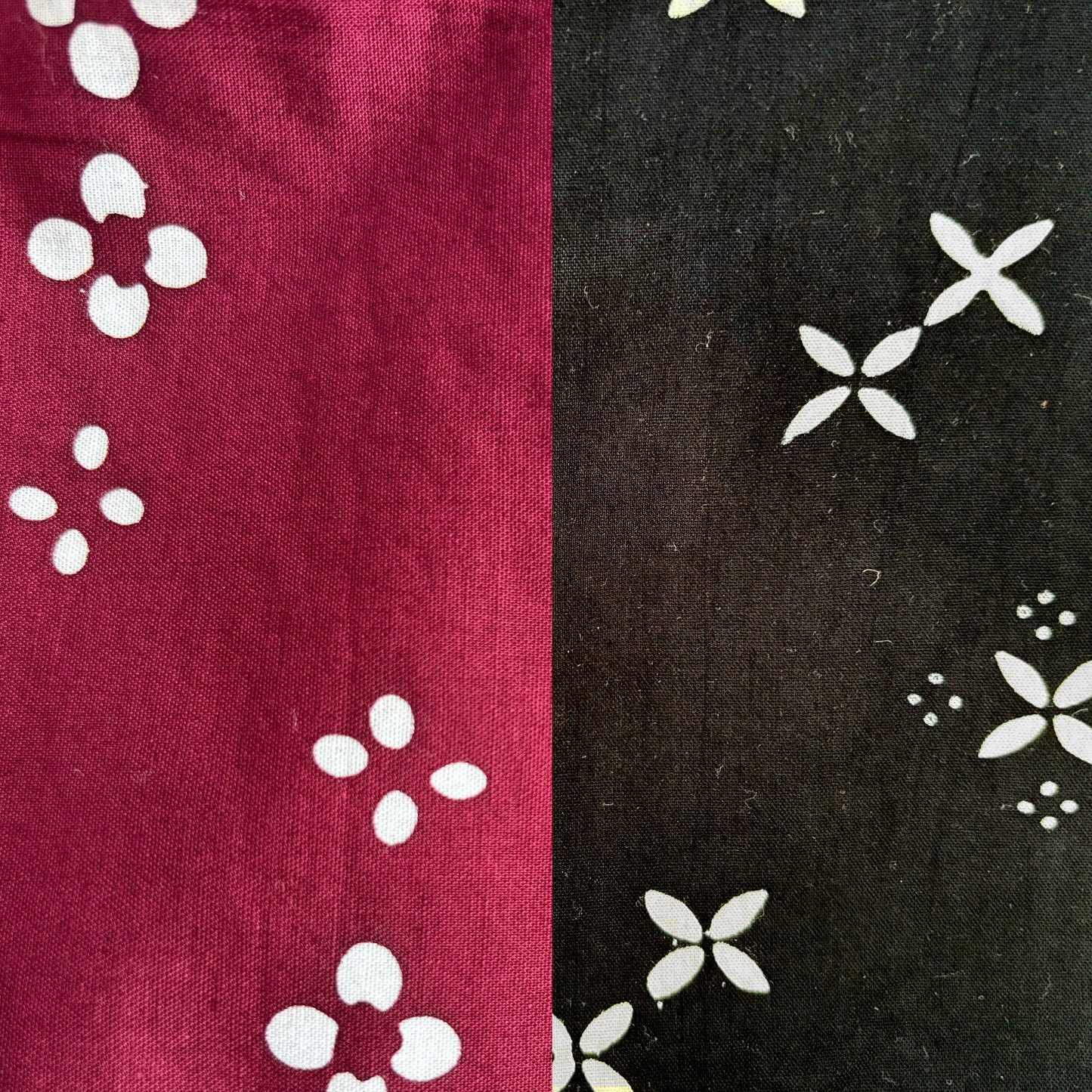 Two fabric swatches with white floral patterns, one on red and one on black.