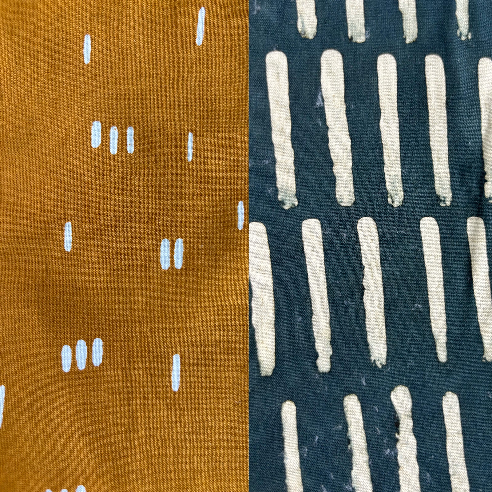 Two fabric swatches with different patterns, one mustard with white lines and the other blue with white lines.