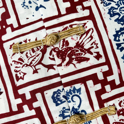 Gold frog buttons and Chinese lacquered print on a batik shirt