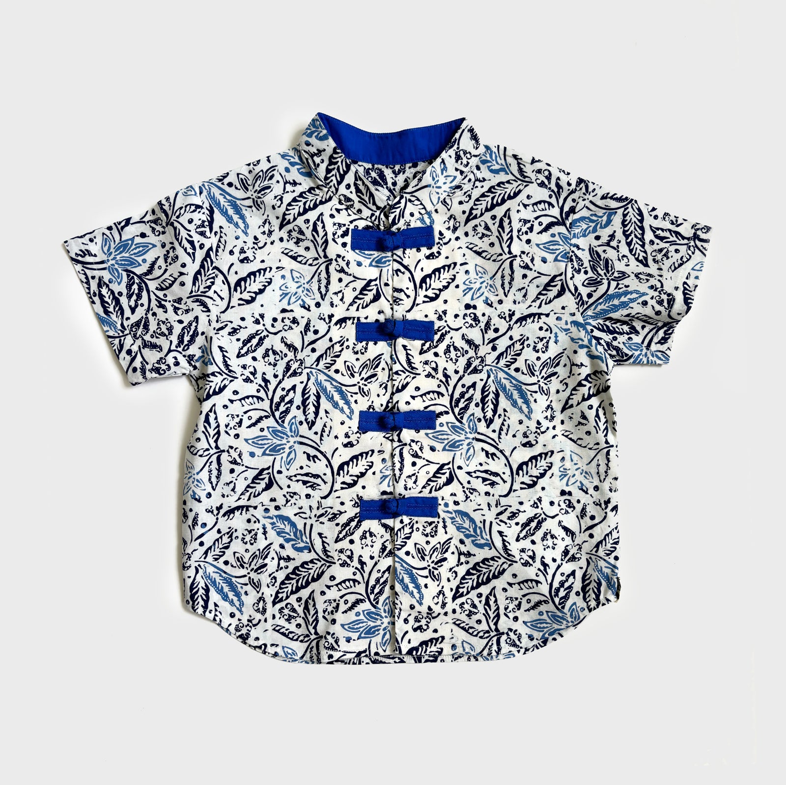 Blue and white floral batik cheongsam shirt with blue mandarin collar and frog buttons