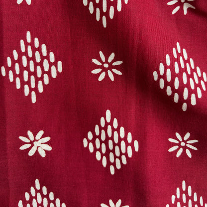 Close up of the red hand stamped batik diamond motif
