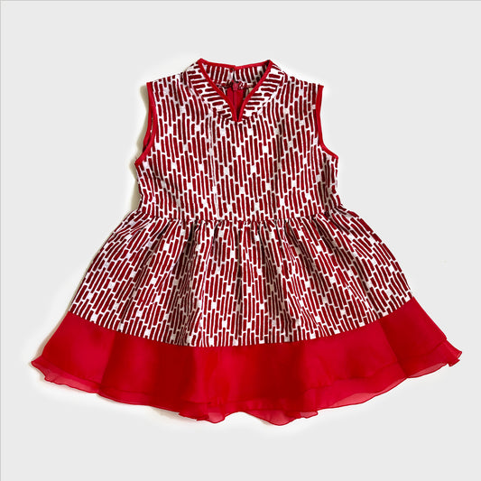 Flat lay of a red batik dress with a flare skirt