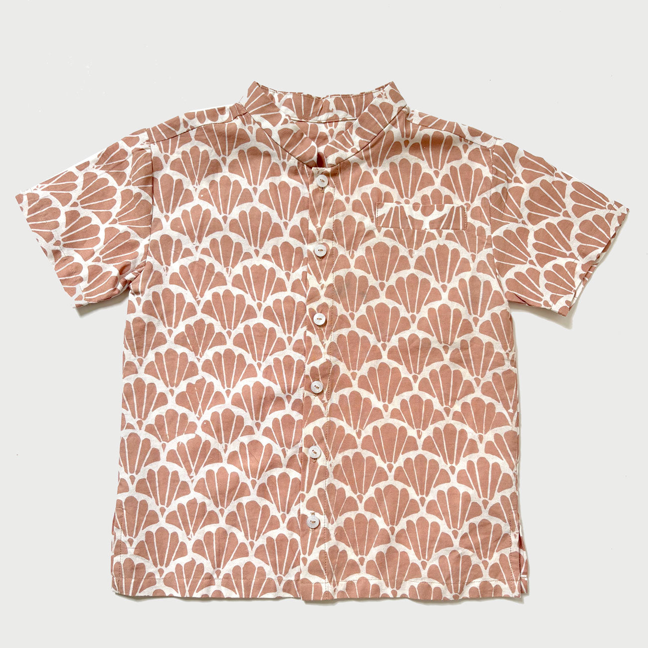 Flat lay of a batik shirt with a scallop design in a dusty mocha color