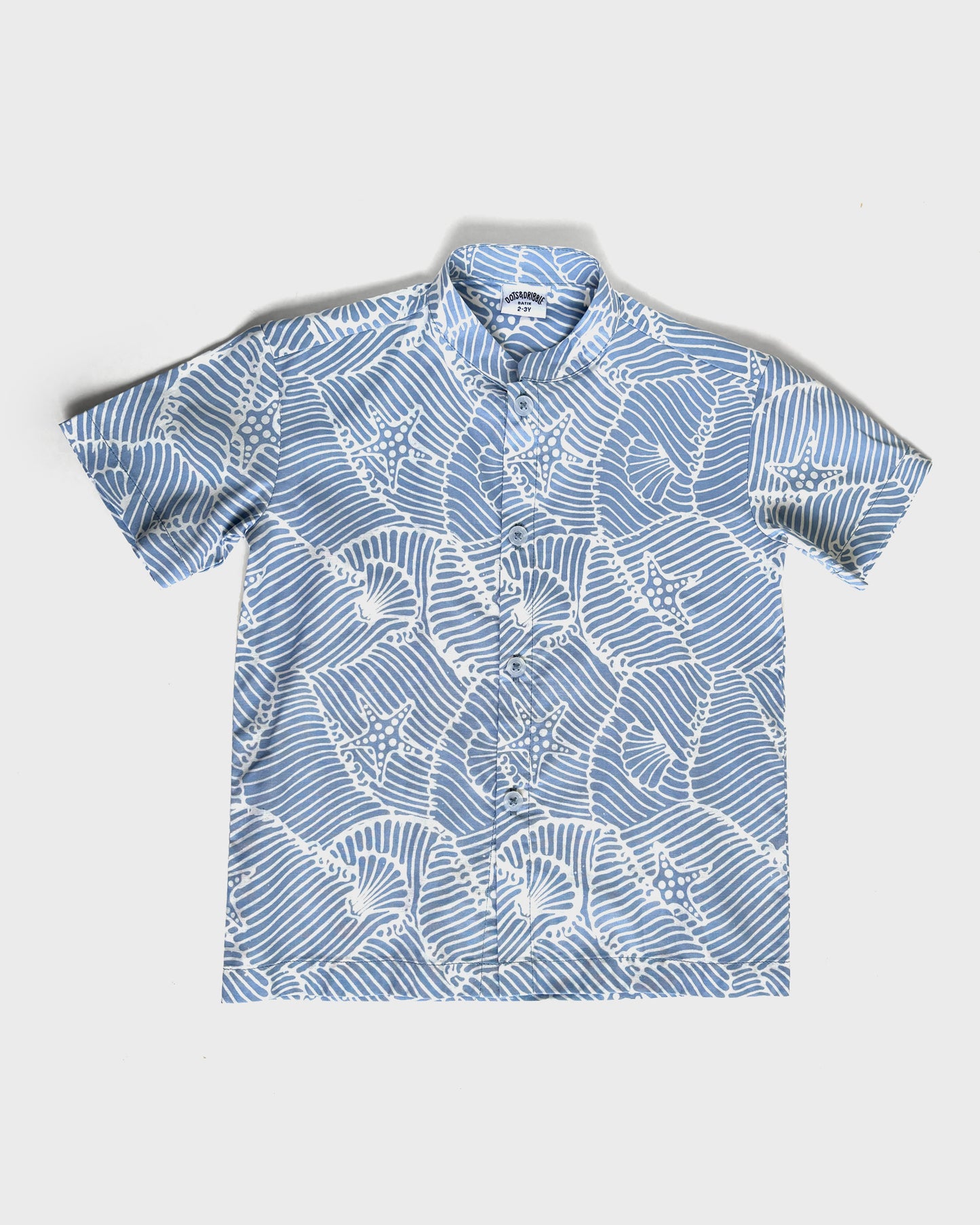 Blue batik seashell shirt on a white background