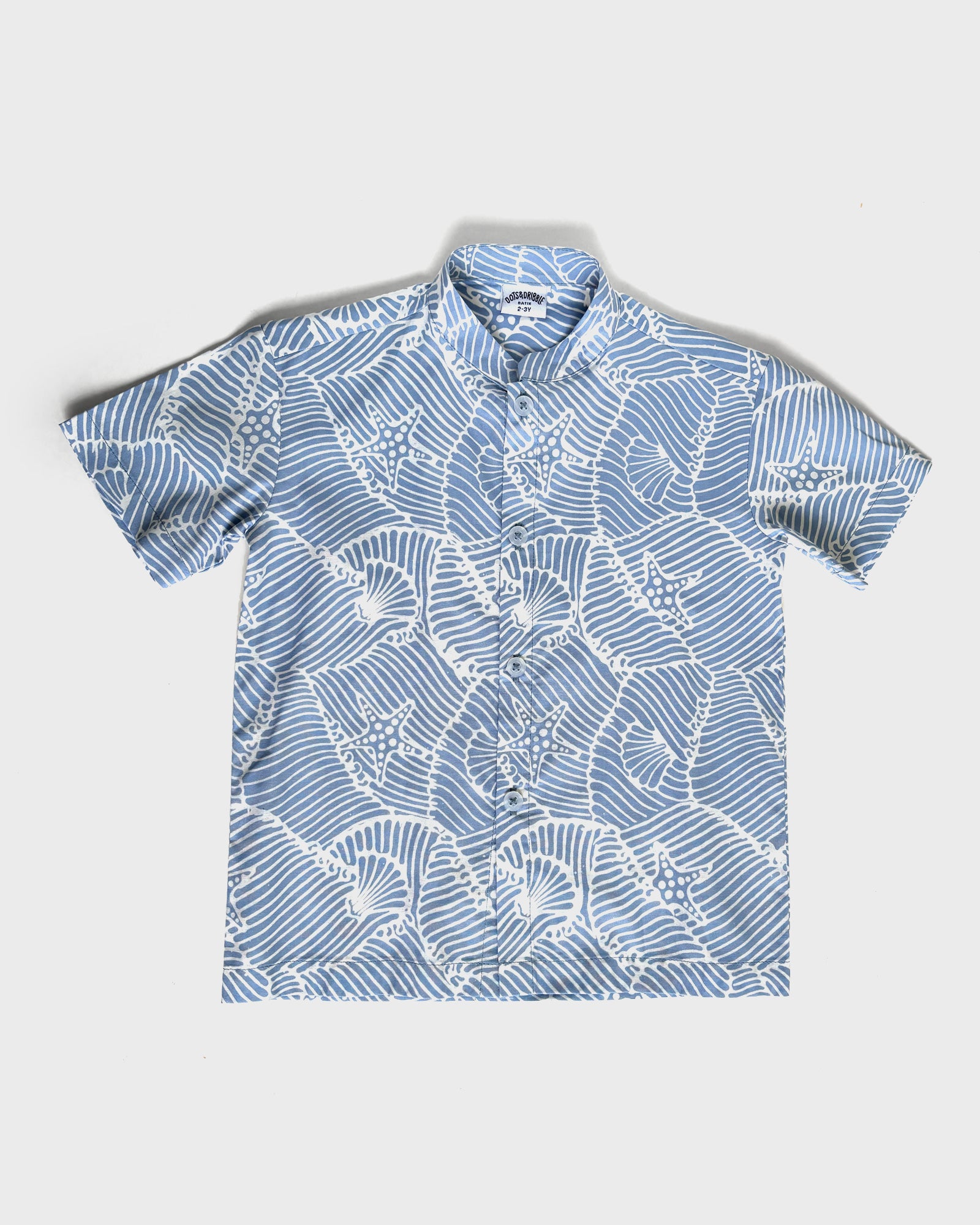 Blue batik seashell shirt on a white background