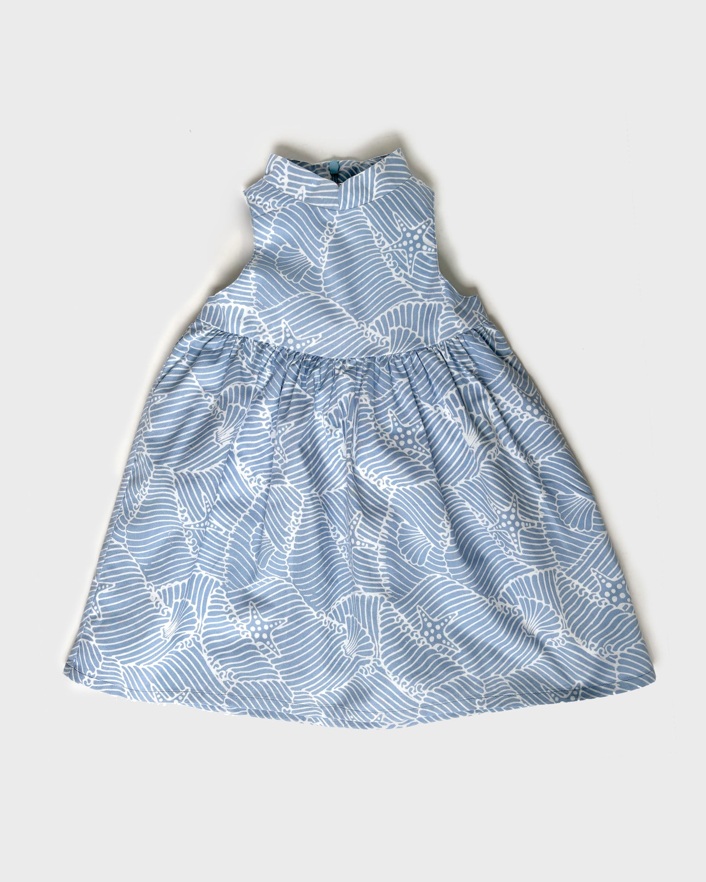 Pastel blue batik patterned dress on a light gray background