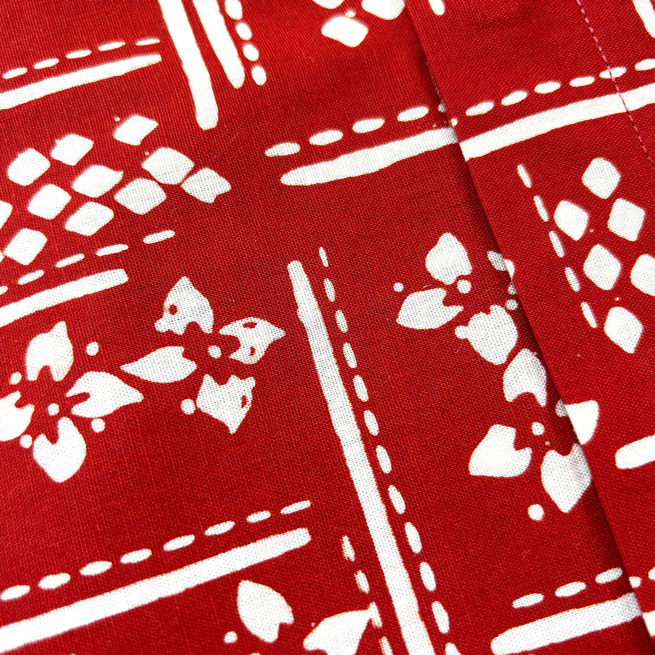 Close up for red batik fabric and flower motif