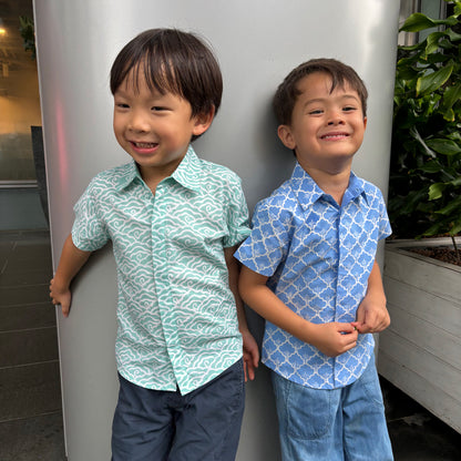 Boys wearing their blue and green batik shirts