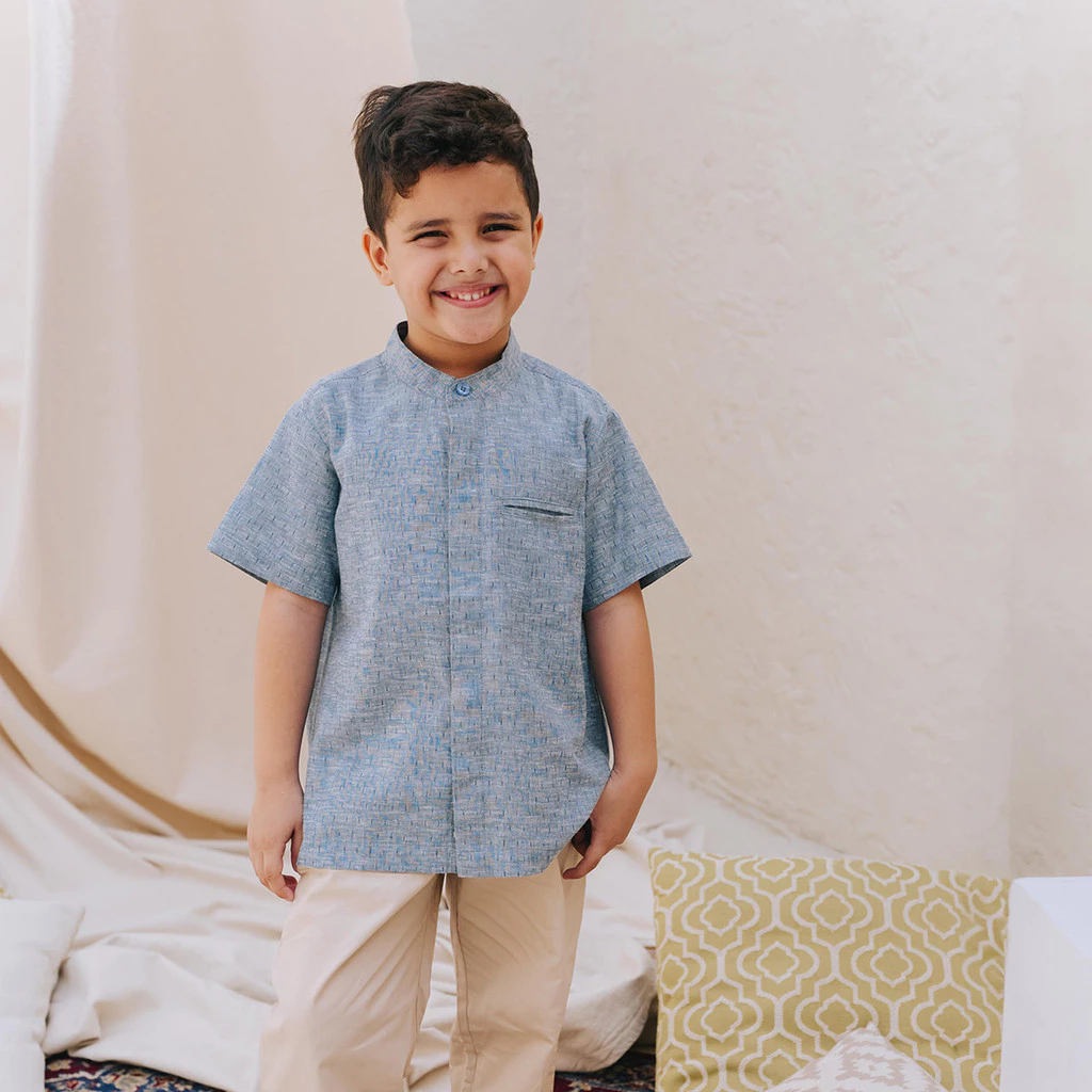 Boy wearing a blue cotton shirt with a high collar