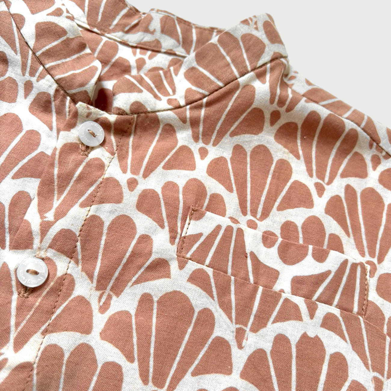 Mandarin collar of a batik shirt featuring the scallop design